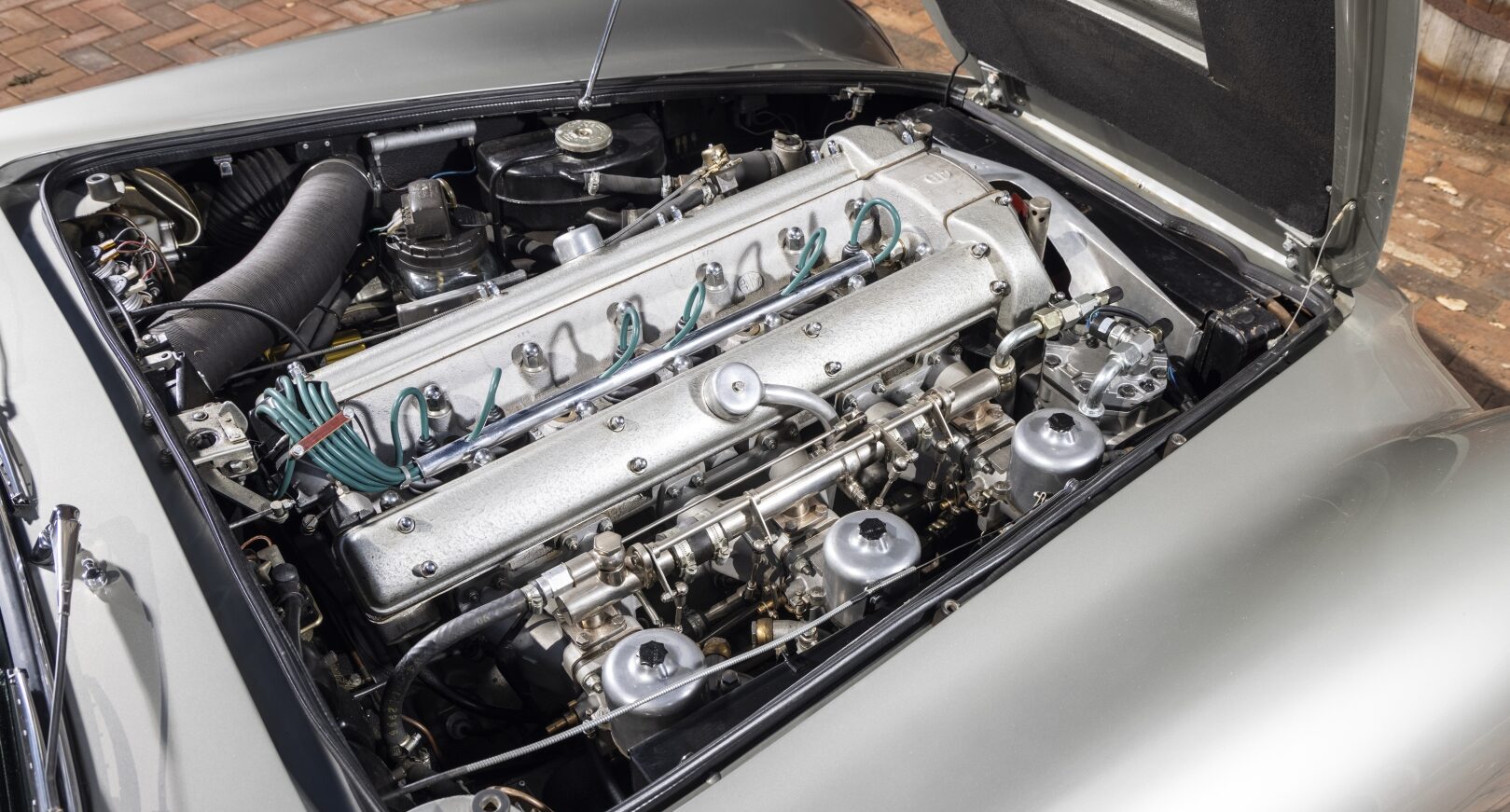 Engine of silver Aston Martin DB5