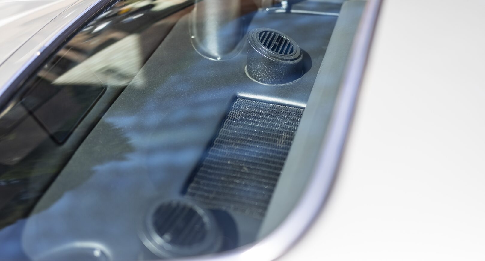Rear window of silver Aston Martin DB5