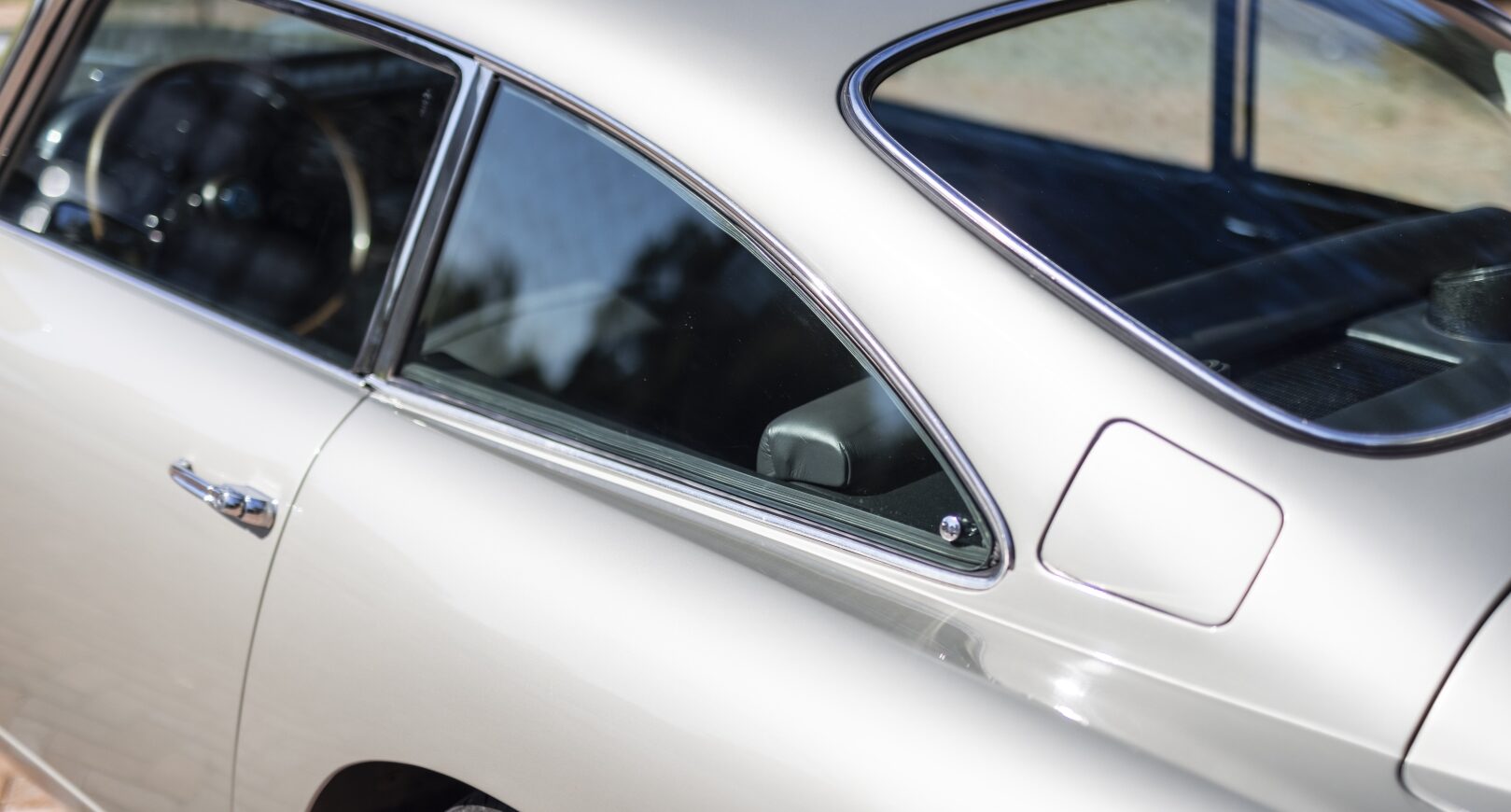 Rear detail photo of silver Aston Martin DB5