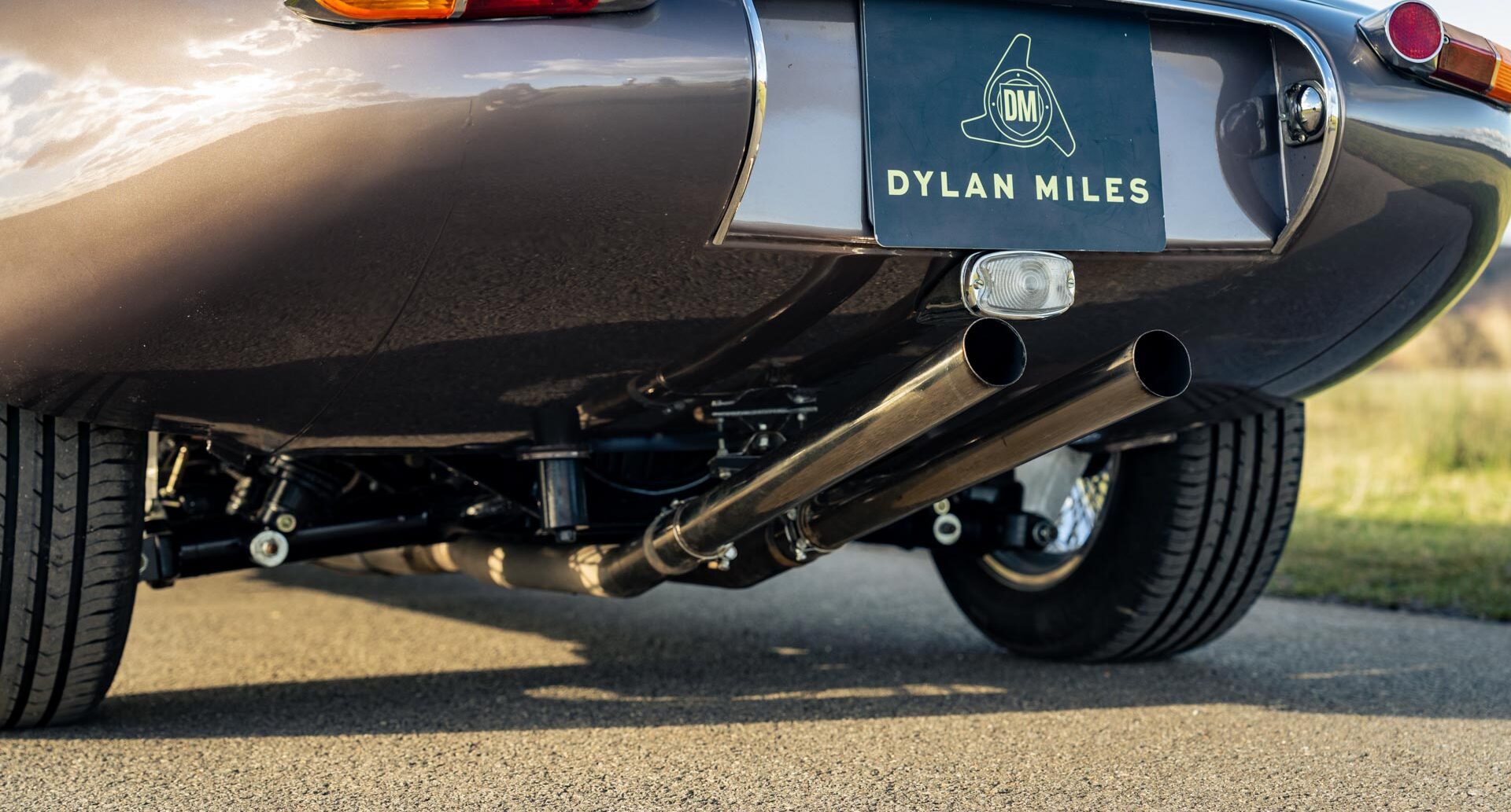 Photo showing tail pipes of classic Jaguar V12 E Type Roadster