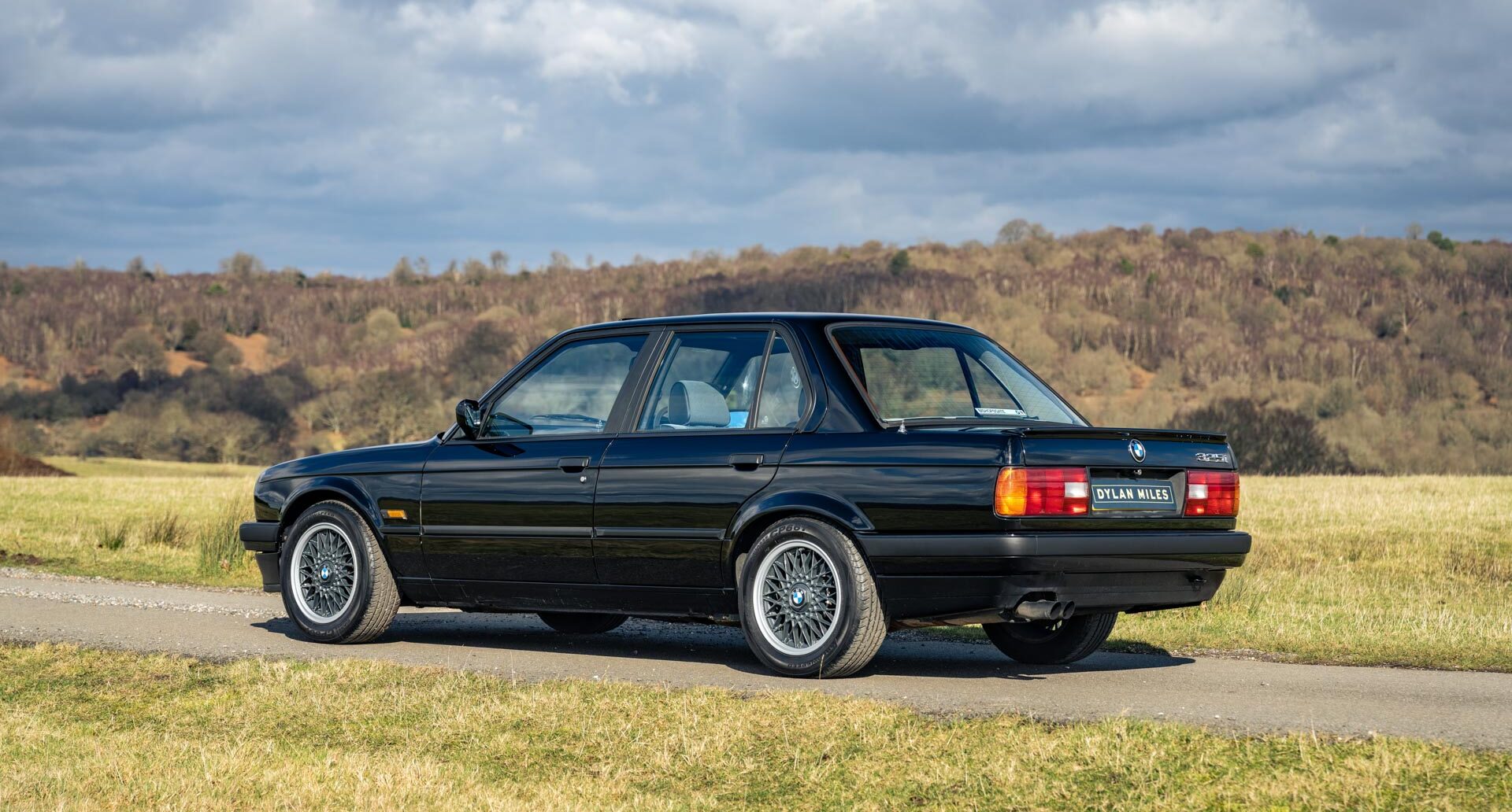 Rear side view of Schwarz Black 1990 BMW E30 325i Saloon