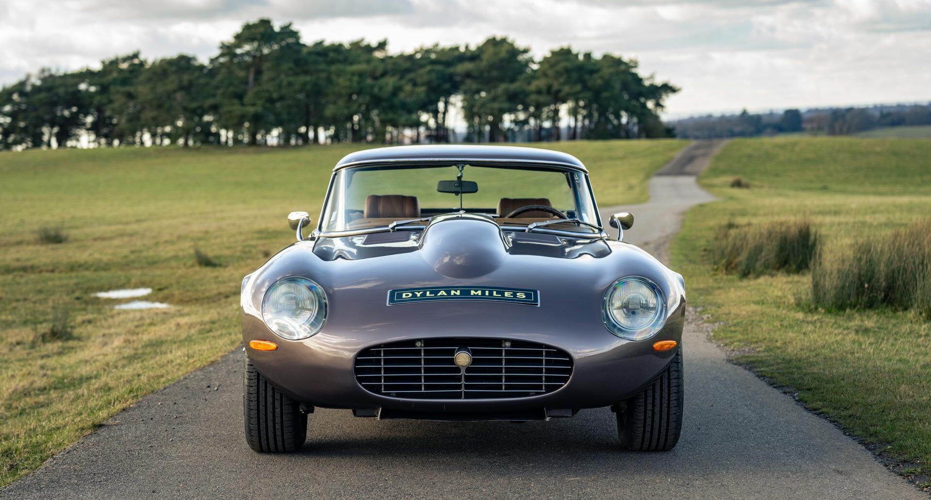 Front view of collectible Jaguar V12 E Type Roadster with hard top